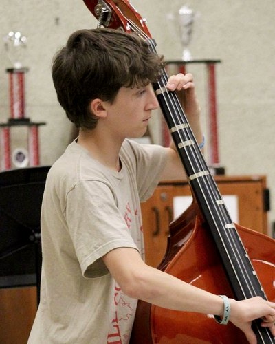 A young bassist rehearses with his orchestra